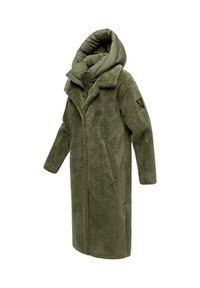 Olijfgroene lange jas met een fluffy textuur, een oversized capuchon en zijzakken. Heeft een kraag en een patch op de linker mouw.