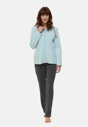 Light blue zip-up fleece jacket with gray accents, paired with dark gray, loose-fitting sweatpants. Smooth fabric texture.