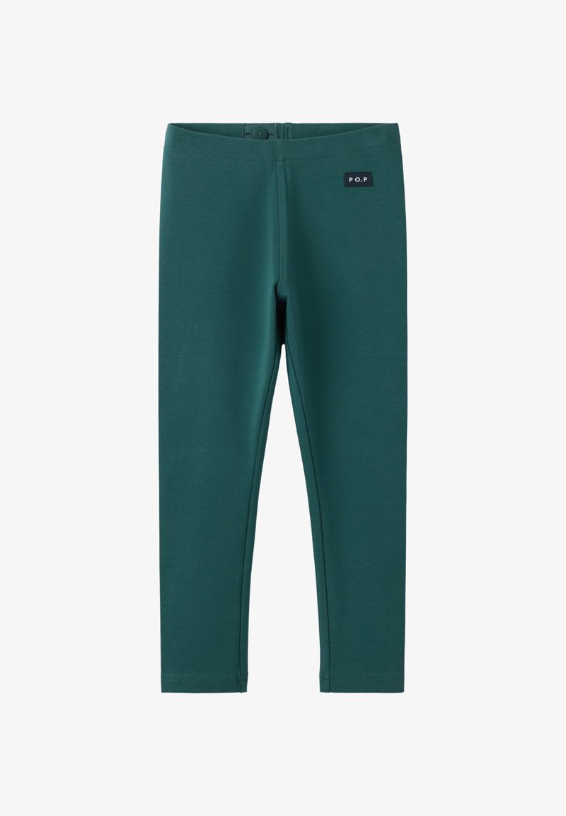 Leggings verts en tissu extensible, avec une texture lisse et une petite étiquette noire sur la taille. Sans motifs ni détails métalliques.