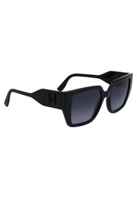 Oversized black sunglasses with a matte finish, square frames, gradient lenses, and an engraved logo on the temple.
