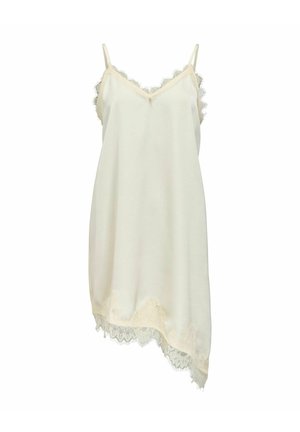 Robe nuisette en satin crème avec bordure en dentelle le long du décolleté en V, des côtés et de l'ourlet asymétrique, avec fines bretelles ajustables.