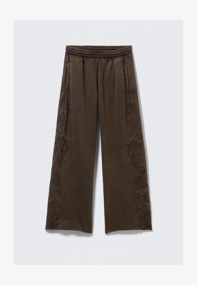 Pantalon large marron avec une ceinture élastique, présentant des motifs floraux brodés complexes sur les côtés. Confectionné dans un tissu doux.