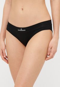 Slip-uri negre din bikini cu o textură netedă și o talie lată, prezentând un logo alb "COPENHAGENA". Design simplu, minimalist.