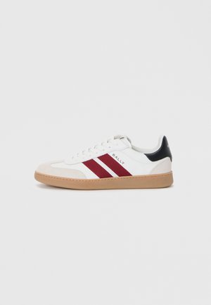 White low-top sneakers featuring two maroon stripes, a suede toe cap, and a black accent at the heel, with a gum sole.