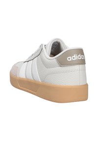 Adidas sneakers in white leather with grey accents, textured sides, and three white stripes. Rubber outsole in beige for grip and durability.