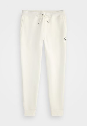 Pantalons de jogging blancs en tissu doux, dotés d'une taille élastique avec cordon de serrage, de poches latérales et d'un petit logo noir sur la jambe inférieure.