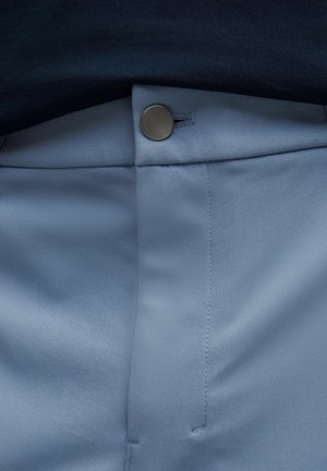 Light blue fabric pants featuring a smooth texture, a button closure, and visible stitching details along the waistband and side seam.