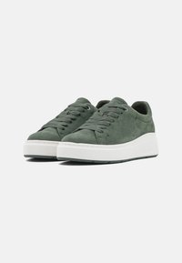 Green suede sneakers with flat laces, white rubber sole, rounded toe, and minimal stitching detail. Lightweight design with a smooth texture.