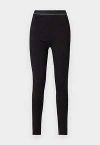 Leggings noirs en matière extensible, avec une coupe ajustée et une taille arborant le logo "HUGO" en couleurs contrastées.