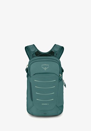 Sac à dos compact Osprey Syncro 12 bleu sarcelle avec bretelles matelassées et plusieurs compartiments zippés à l'avant sur fond blanc.