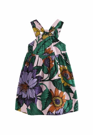 Robe sans manches avec larges bretelles croisées dans le dos, présentant un grand imprimé floral coloré avec des feuilles vertes sur un fond clair.