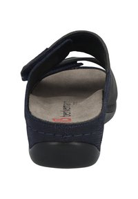Navy blue sandal with a textured upper, velcro strap, and a cushioned beige insole. Black outsole with rounded toe and slight heel.
