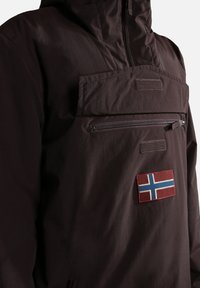 Brown hooded jacket made of lightweight material. Features a front zip pocket and a Norway flag patch on the chest.