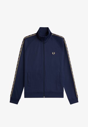 Marineblå lynlåstræningsjakke med gyldent laurbærlogo på brystet og matchende gyldne laurbærstriber langs ærmerne.