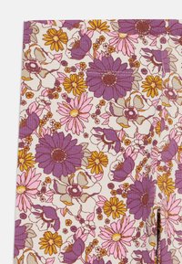 Tessuto a fantasia floreale con fiori viola, rosa e giallo su uno sfondo crema. Materiale texturizzato e ribbed con dettagli fini.