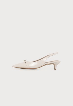 Lesklá béžová slingback topánka so špicatou špičkou, nízkym kitten opätkom a malou kovovou prackou pri špičke.