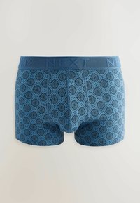Blue patterned boxer shorts featuring a textured design with intricate shapes. The waistband is a solid blue with "NEXT" embossed.