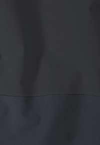 Dark gray fabric with a horizontal seam and subtle grid texture, showing soft folds and shadows.