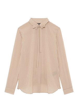 Blouse beige à manches longues avec des pois rouges, un col et un détail de nœud à l'avant, posée à plat sur un fond blanc.
