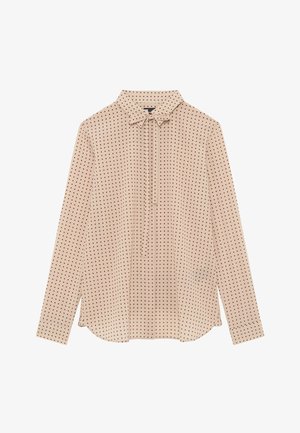 Beige bluse med lange ærmer, røde prikker, krave og frontknude-detail, lagt fladt på en hvid baggrund.