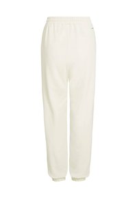 Pantalon de survêtement blanc en tissu doux, doté d'une ceinture élastique et de poignets ajustés. Design simple sans motifs ni accents visibles.