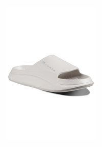 White slip-on sandals with an open toe and a textured footbed. Features a smooth upper and a slight curve in the sole for comfort.