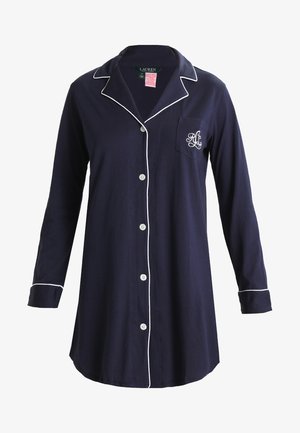 Námornícky modrý pyžamový vrch s dlhými rukávmi, bielym lemovaním a náprsníkom s monogramom. Päť gombíkov na prednej strane. Mäkko bavlnené materiály.