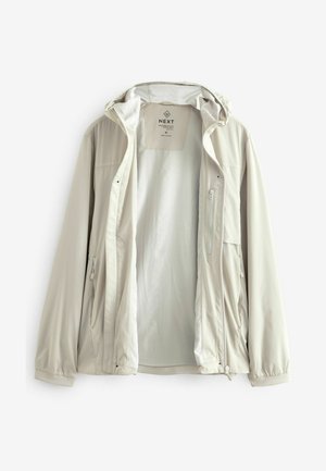 Light beige zip-up jacket with a removable hood, featuring multiple pockets, smooth texture, and elastic cuffs. Inside is a plain lining.