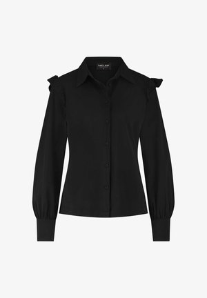Zwarte blouse met lange mouwen, knoopsluiting aan de voorkant, puntige kraag, aansluitende manchetten en ruffles op de schoudernaad.