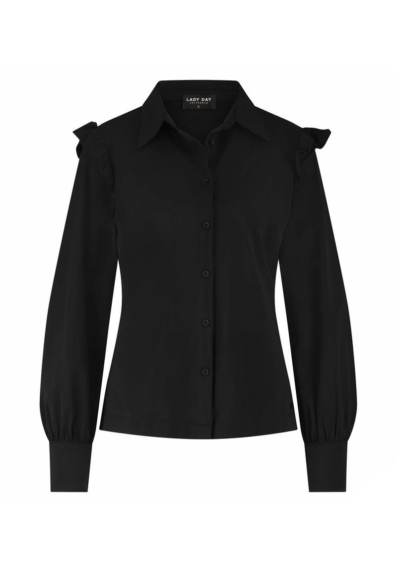 Zwarte blouse met lange mouwen, knoopsluiting aan de voorkant, puntige kraag, aansluitende manchetten en ruffles op de schoudernaad.