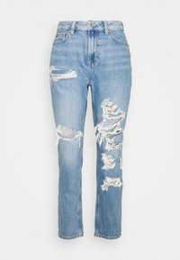 Jean en denim bleu clair à coupe droite, avec plusieurs zones usées, bords effilochés et un design classique à cinq poches.