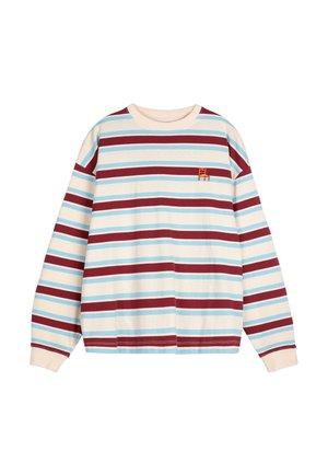 Krátky rukáv tričko s okrúhlym výstrihom v krémovej farbe s horizontálnymi pruhmi v červenej, modrej a svetlomodrej farbe; zdobené malým vyšitým logom na hrudi.