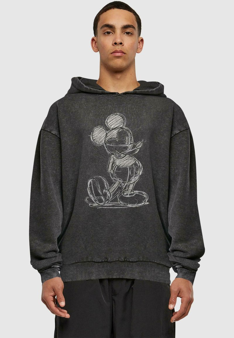 Sudadera negra con un boceto blanco de un personaje de dibujos animados, corte relajado, textura suave, con capucha ajustable y puños acanalados.