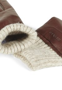 Leather gloves in dark brown with a cream knitted wool cuff. The cuff features ribbed texture and a tag labeled "HOWARD."