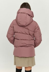 Puffer jacket in muted mauve, featuring a hood, quilted design, and a slightly longer back hem. Fabric appears smooth and water-resistant.