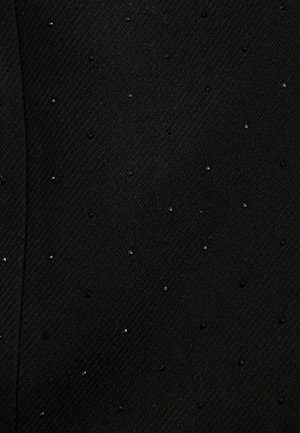 Schwarzer Stoff mit einer strukturierten diagonalen Webart, verziert mit kleinen glänzenden Akzenten, die in einem verstreuten Muster angeordnet sind.