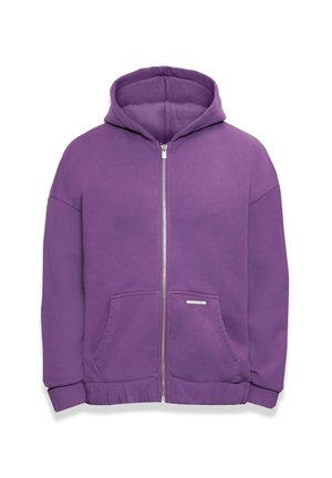 Lilla tõmbluku jiguvärviga kapuutsiga jakk, millel on ees taskud ja soonikkoes mansetid. Sile kangas, lõtv lõige ja väike brändi silt taskul.