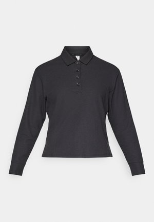 Zwarte longsleeve poloshirt met een geribbelde textuur, knoopsluiting en een klassieke kraag. Materiaal biedt rek en comfort.