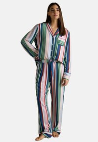 Striped pajama set featuring multicolored vertical stripes in green, blue, pink, and red. Long-sleeved shirt with a chest pocket and drawstring pants.