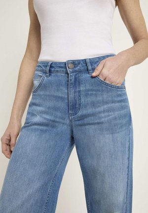 Light blue denim jeans with a straight-leg design, high waist, visible front pockets, and a metal button closure. Smooth texture.