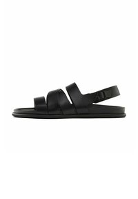 Black sandal featuring multiple horizontal straps and a buckle closure. The sole is flat with a smooth texture and minimalistic design.