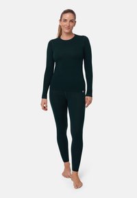 Green long-sleeve top and fitted leggings made from a soft, textured fabric. Both pieces feature a round neckline and minimal branding.