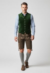 Green velvet vest with five buttons, checkered shirt, brown leather lederhosen with floral embroidery, gray knee-high socks, brown shoes.