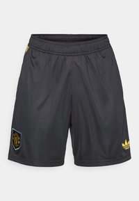 Μαύρα αθλητικά σορτς κατασκευασμένα από ελαφρύ ύφασμα, με ελαστική ζώνη στη μέση, χρυσές λεπτομέρειες και ένα λογότυπο του συλλόγου στην αριστερή πλευρά.
