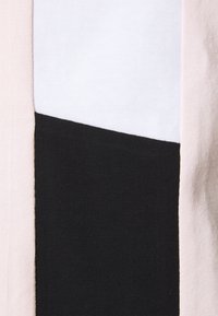Tejido de algodón con un diseño geométrico de bloques de color en rosa, blanco y negro. Material elástico texturizado con un acabado suave.