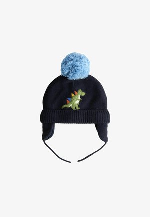 Marineblauwe gebreide muts met een blauwe pompon, met groene dinosaurusborduursels met kleurrijke stekels op de achterkant en oorflappen voor warmte.