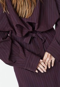 Belted dress in dark plum fabric with thin blue stripes. Features wide sleeves and a cinched waist. Texture appears smooth and slightly draped.