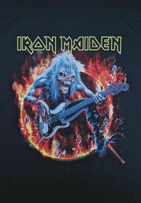 Černé tričko s grafikou zombie-podobné postavy hrající na basovou kytaru uprostřed plamenů, s nápisem "Iron Maiden" nahoře v žluté barvě.