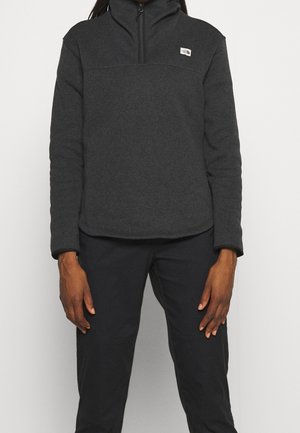 Donkergrijze pullover jack van fleece, met een hoge kraag, halve rits en een klein logo op de bovenste linkerborst.