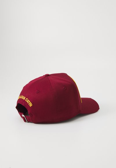 Burgundy adjustable baseball cap with yellow embroidery on the back and a small yellow design on the side of the brim.